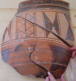 ancient pottery being pieced back together